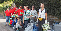 Caritas-Mitarbeiter und Ehrenamtliche sammeln Müll am Rheinufer.